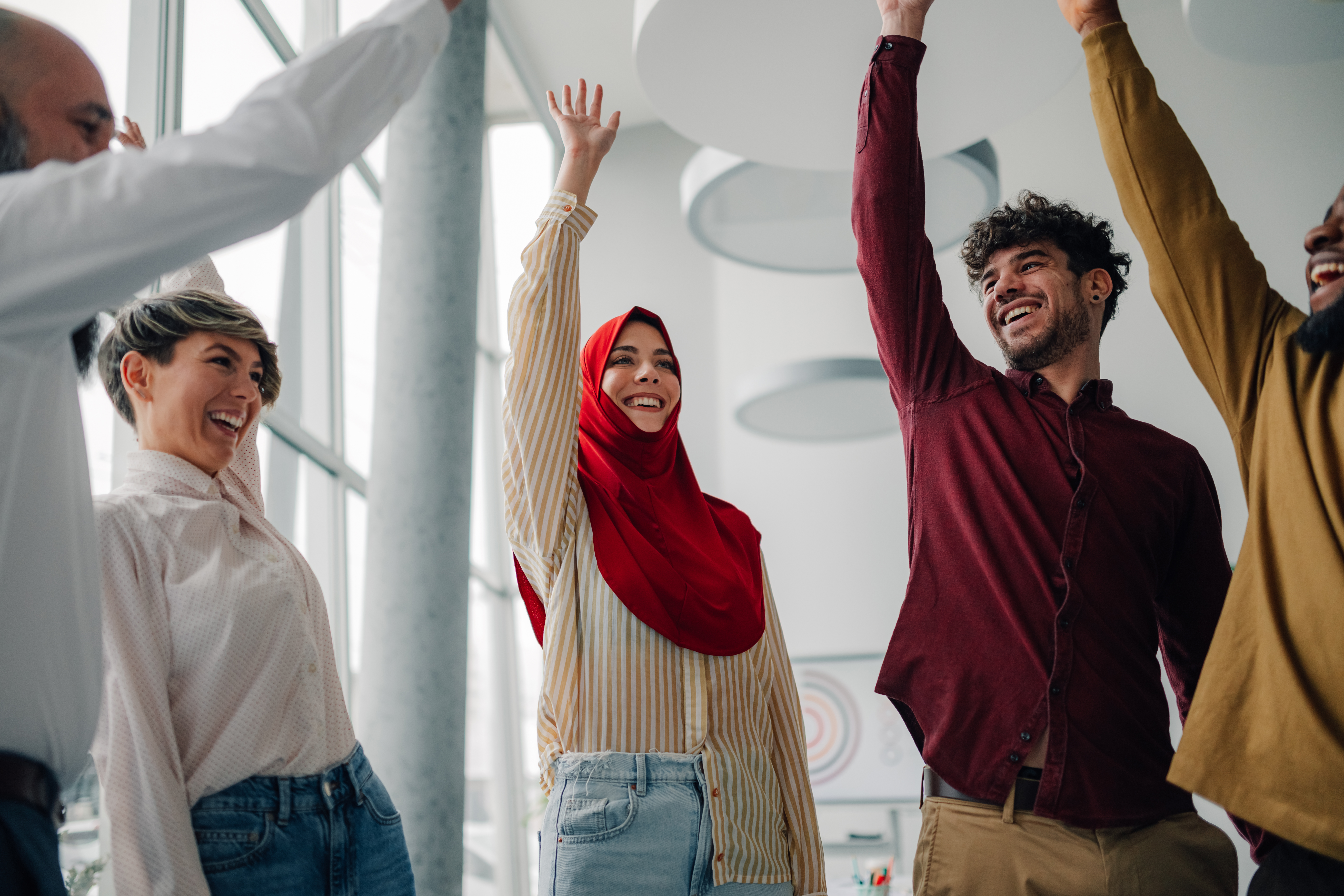 Happy multi-ethnic business team celebrating success