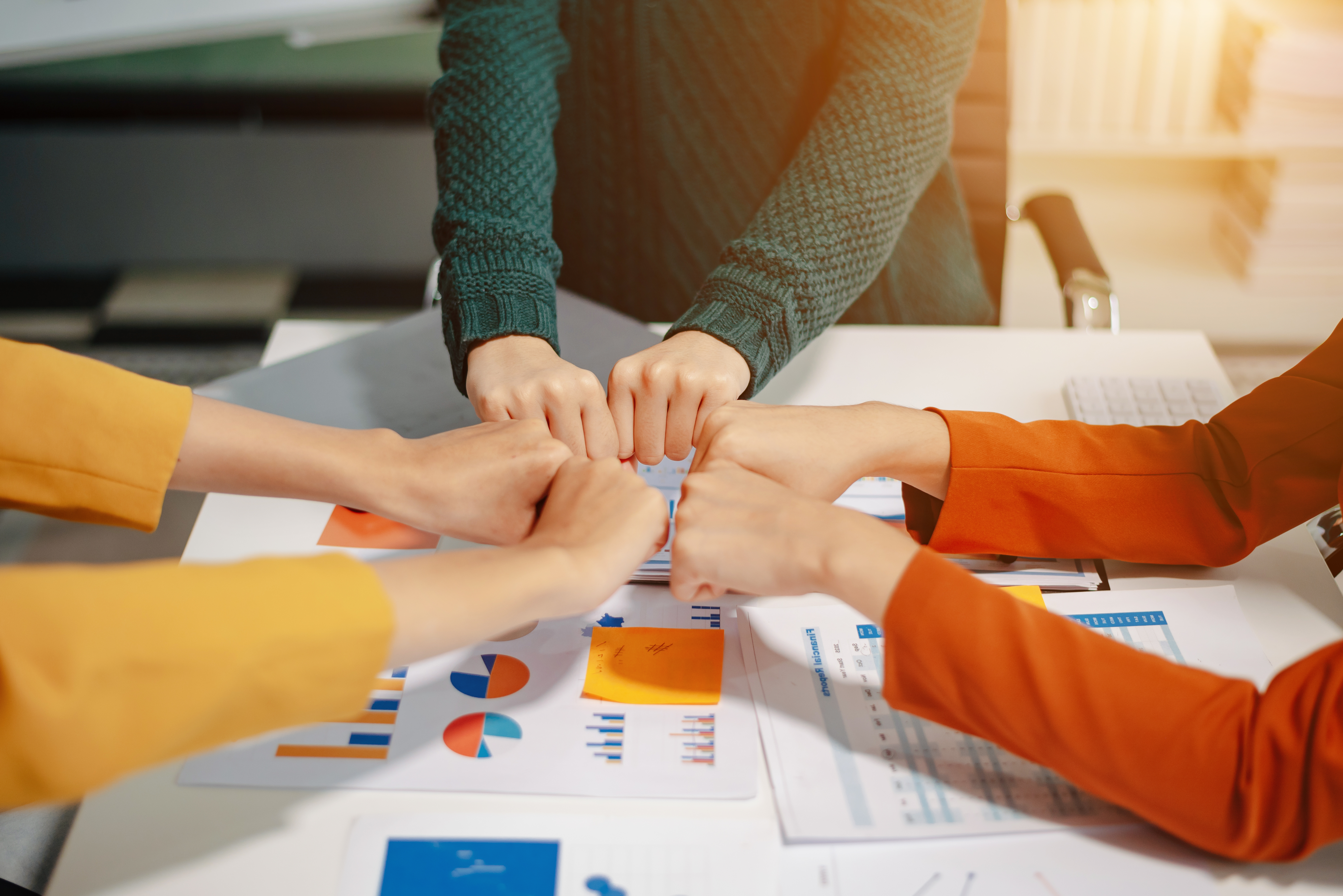 Business people joining hands together representing team collaboration