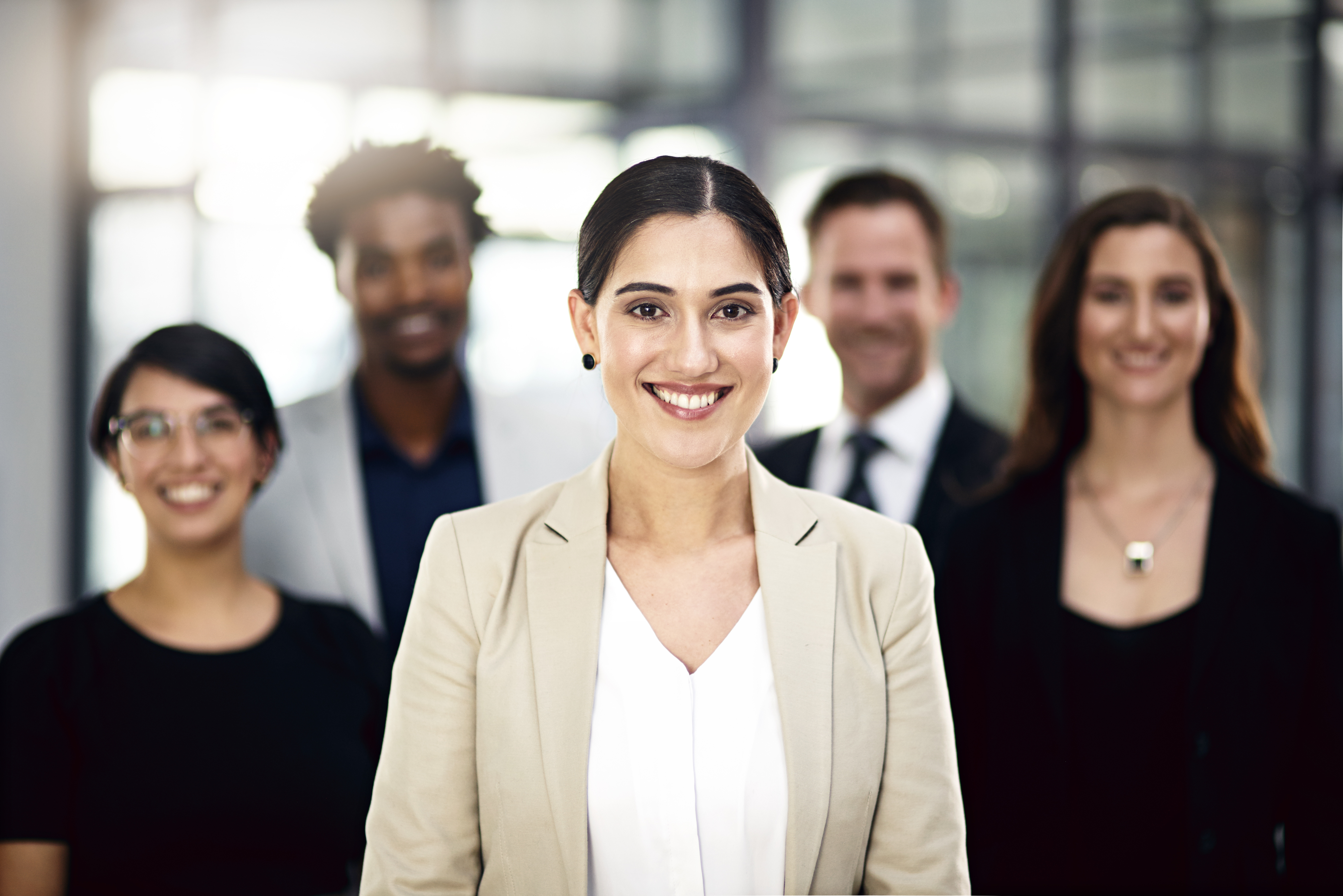 Confident business team smiling in modern office